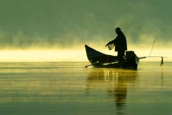 Photo of a man on a boat fishing